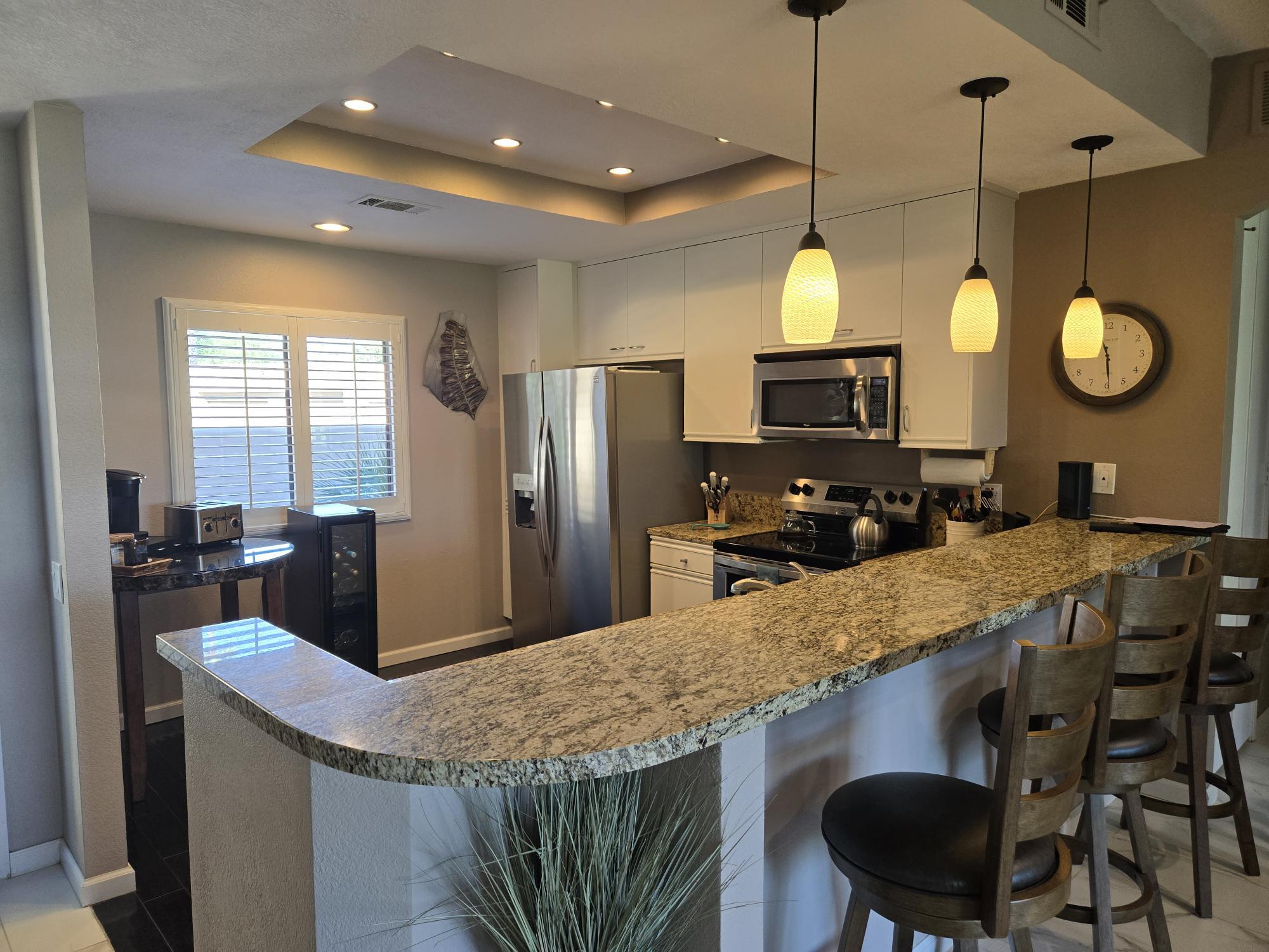 a kitchen with cabinets and stainless steel appliances