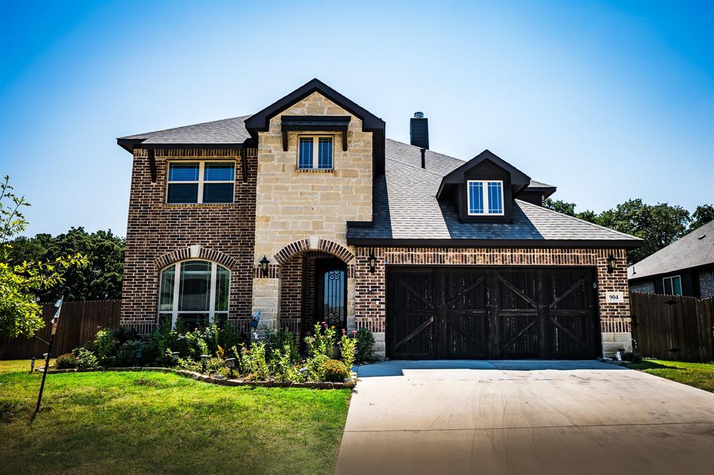 a front view of a house with a yard and garage