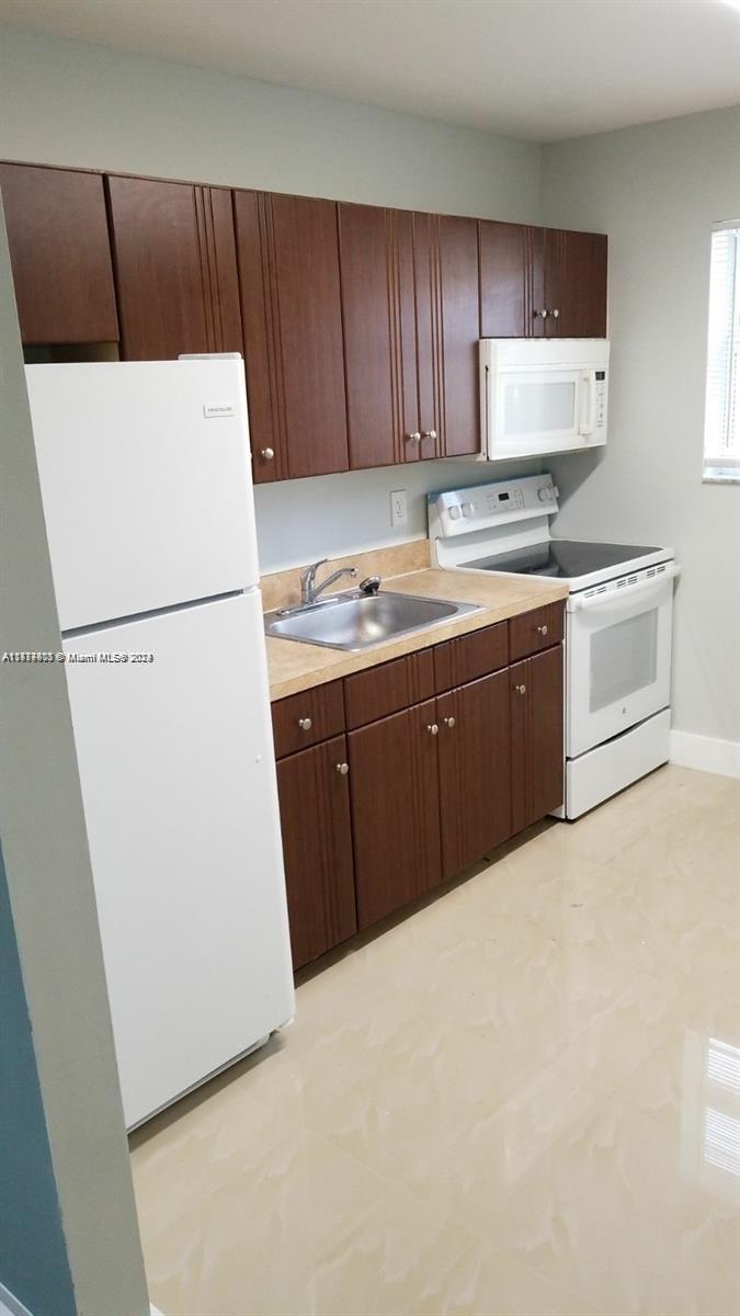 a white refrigerator freezer sitting in a kitchen