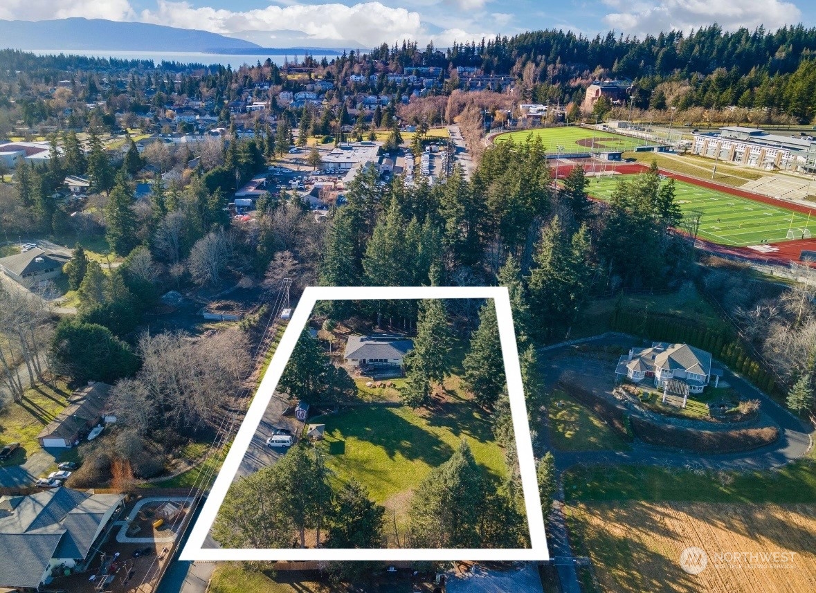 an aerial view of residential houses with outdoor space and river