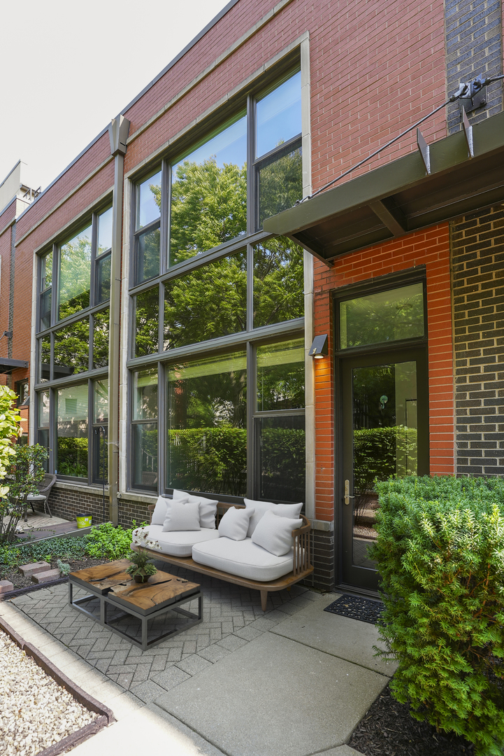 a backyard of a house with outdoor seating