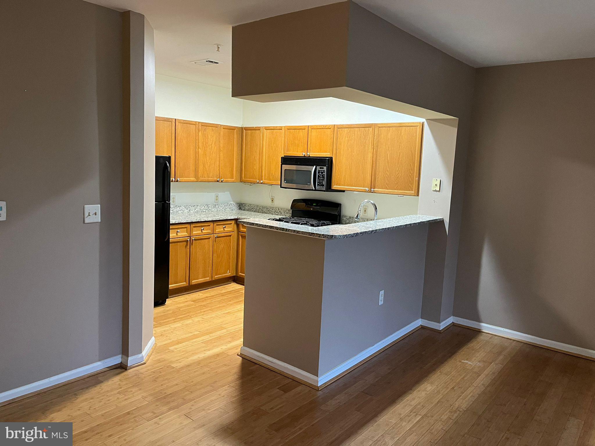 a kitchen with stainless steel appliances granite countertop a sink and a microwave