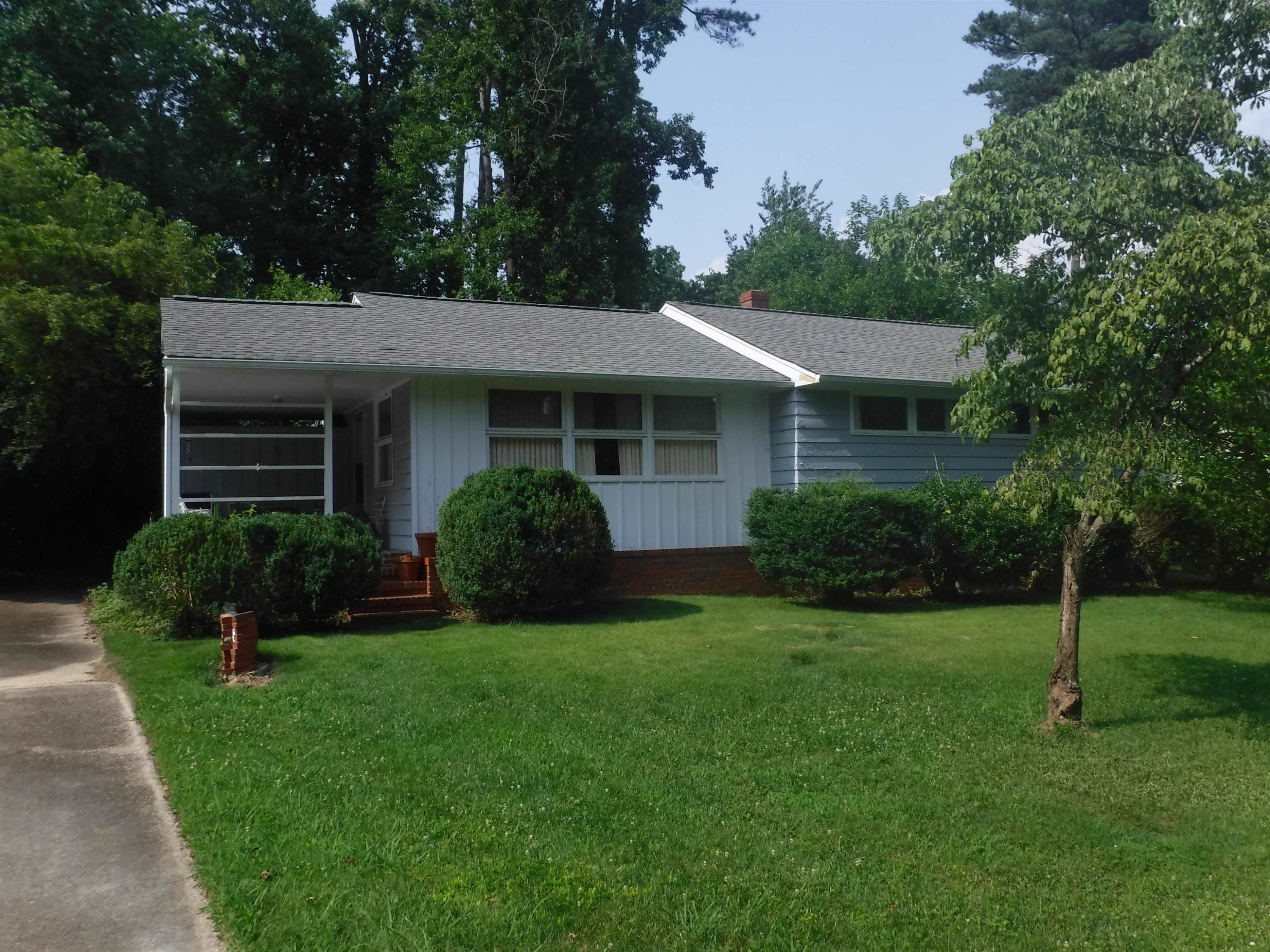 a view of a house with a yard and plants