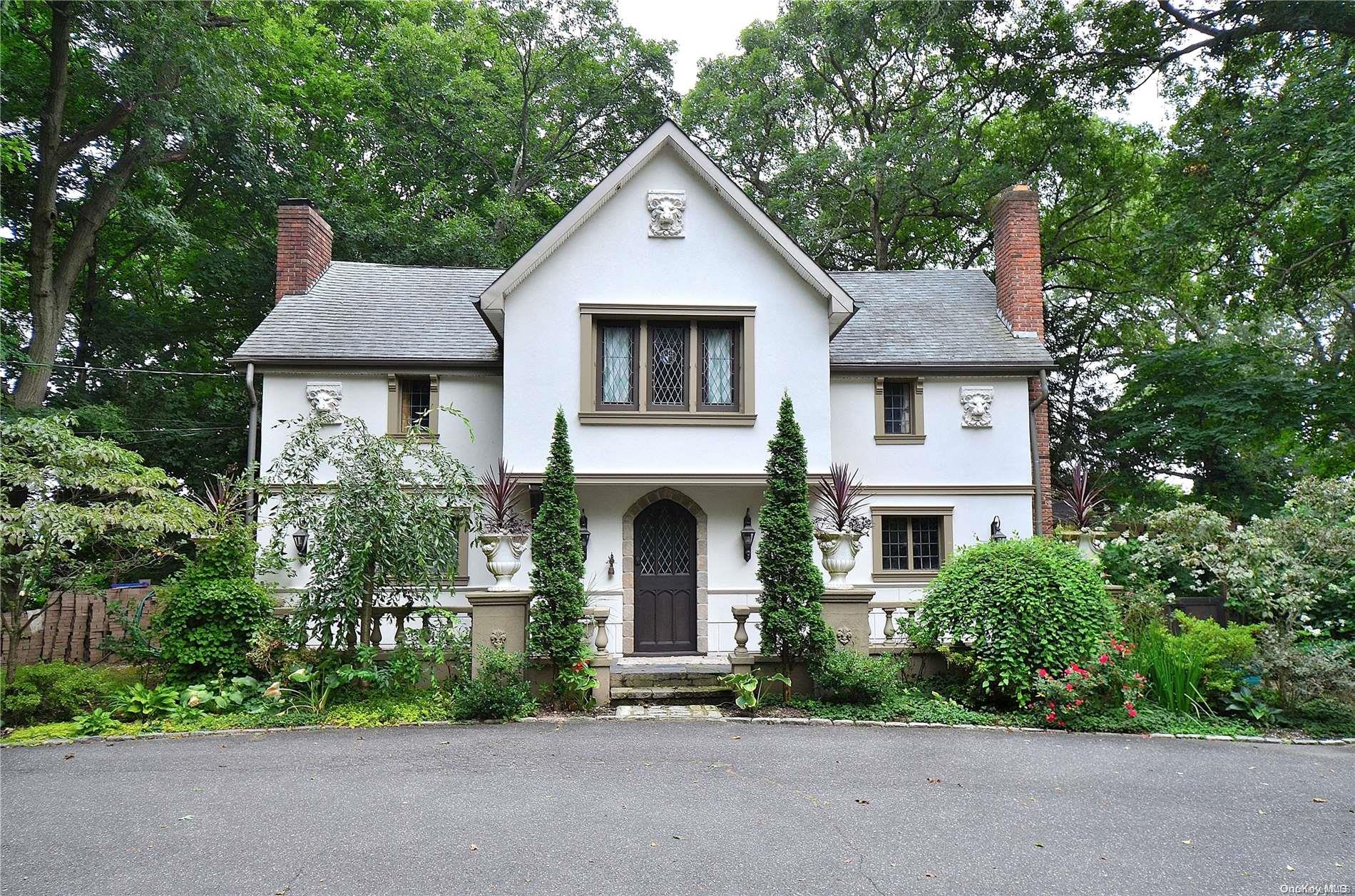 a front view of a house with a garden