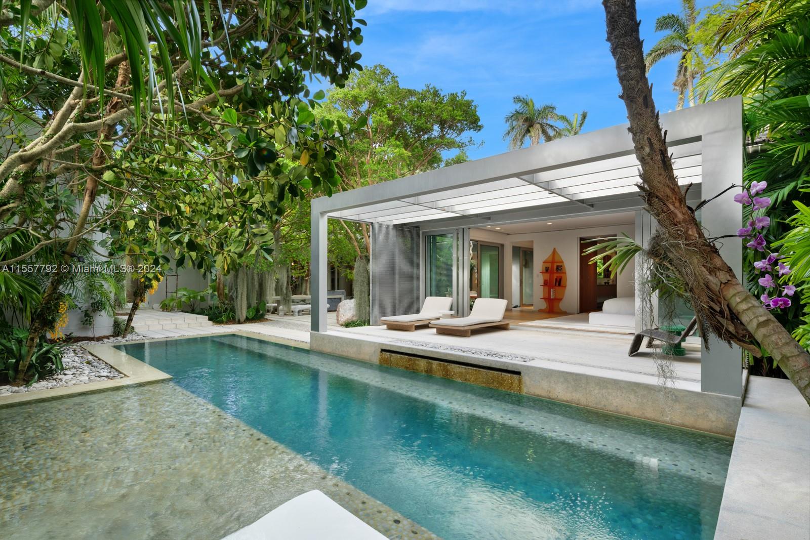 a view of a house with swimming pool and sitting area