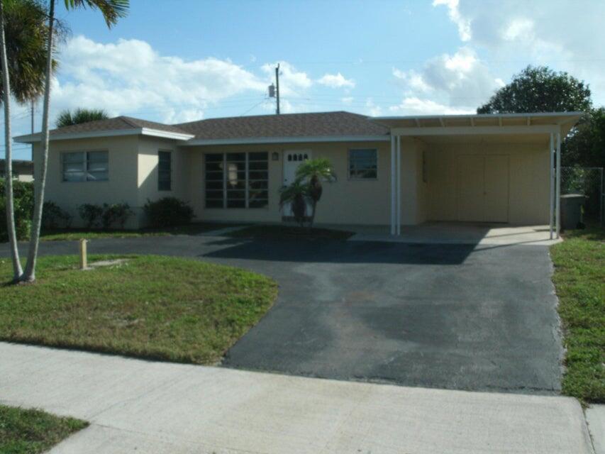 a front view of house with a garden