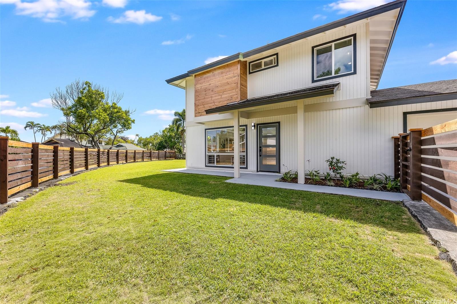 a view of a house with a backyard and a patio