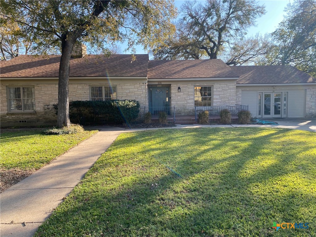 a front view of house with yard and green space