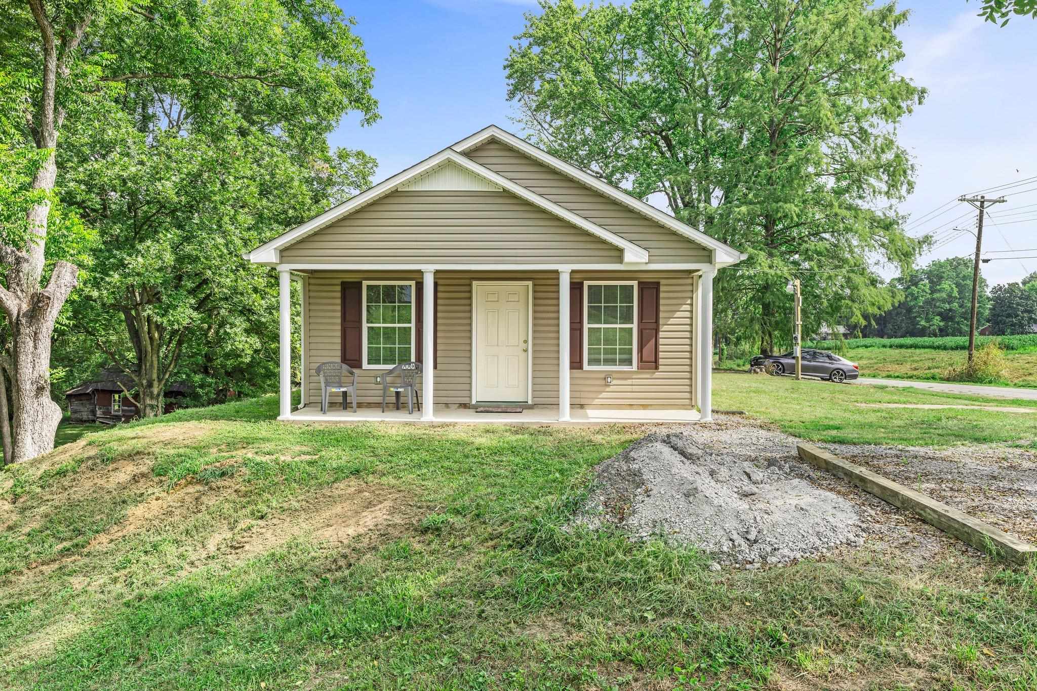 a view of a house with yard and tree s