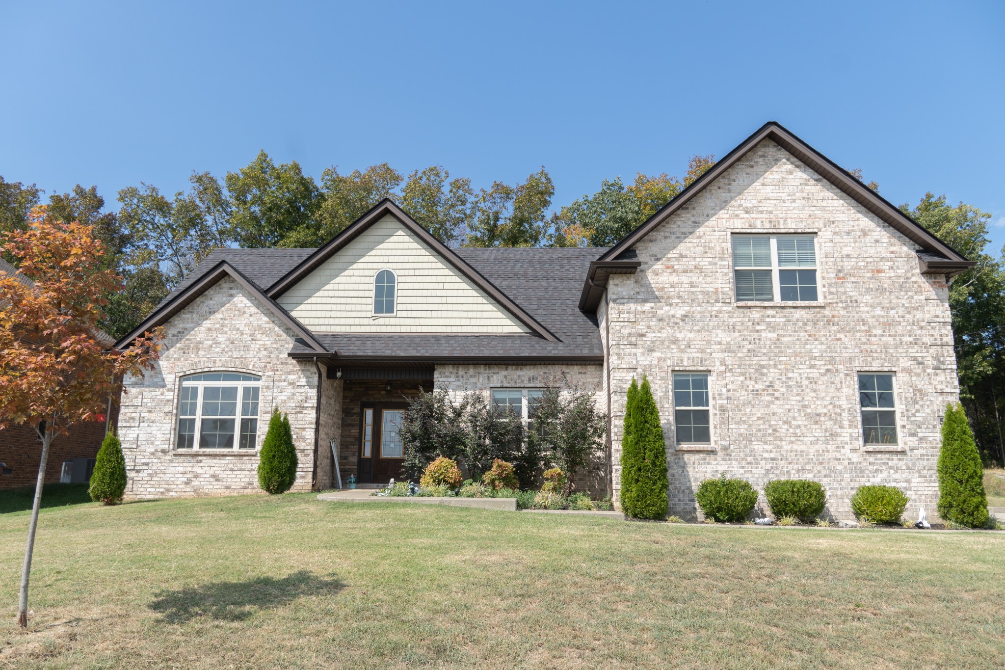 a front view of a house with a yard and porch