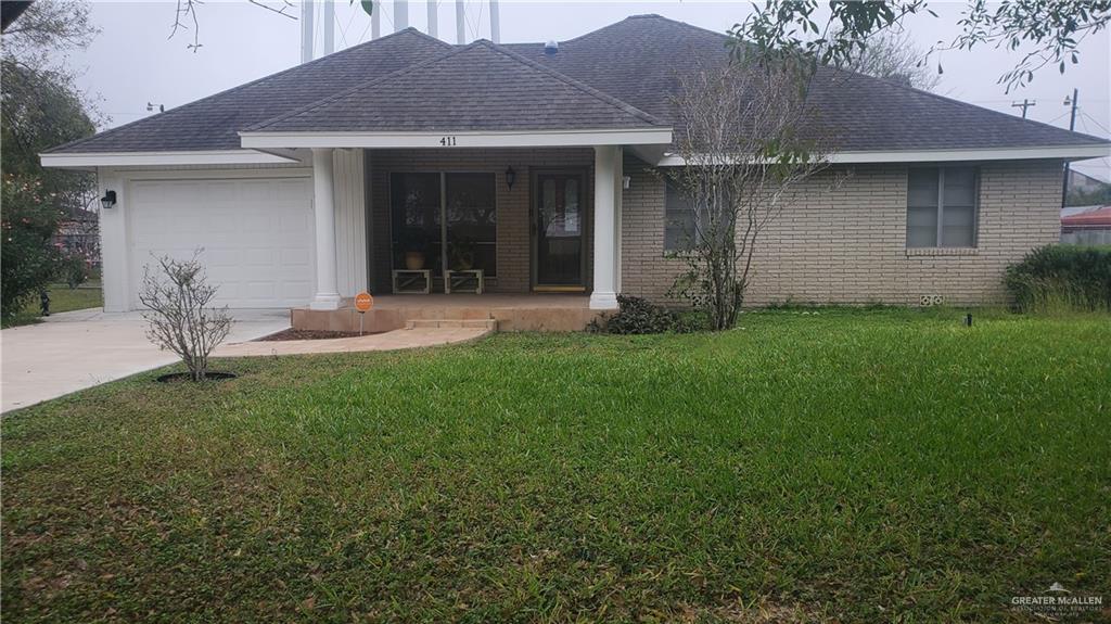 a front view of a house with a yard and porch