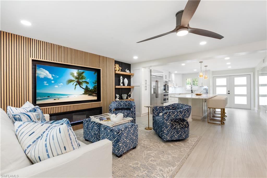 Living room featuring ceiling fan and light wood-type flooring