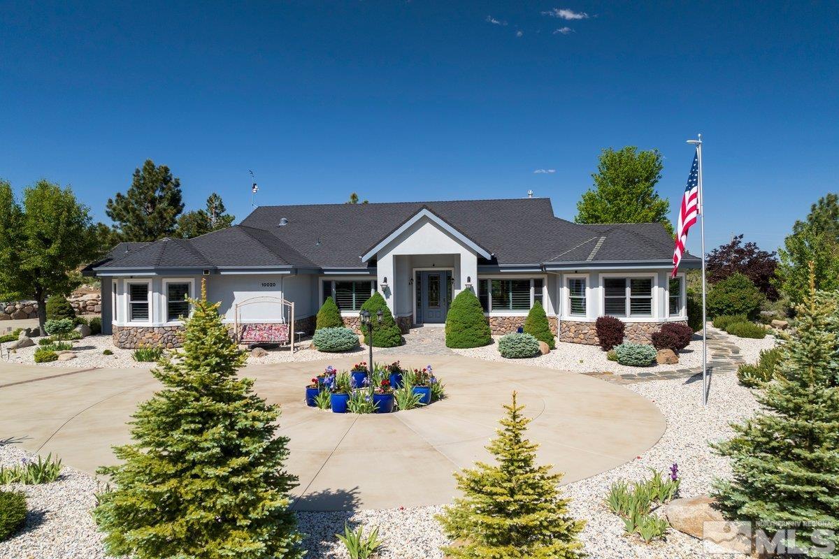 a front view of a house with yard patio and fire pit