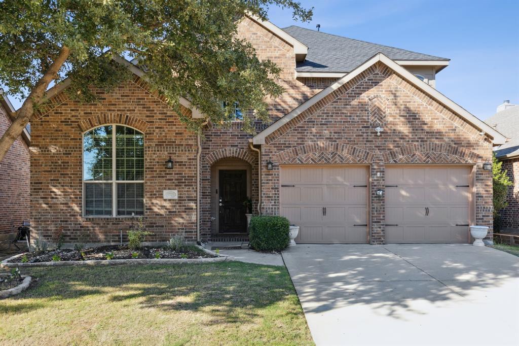 a front view of a house with a yard garage and outdoor seating