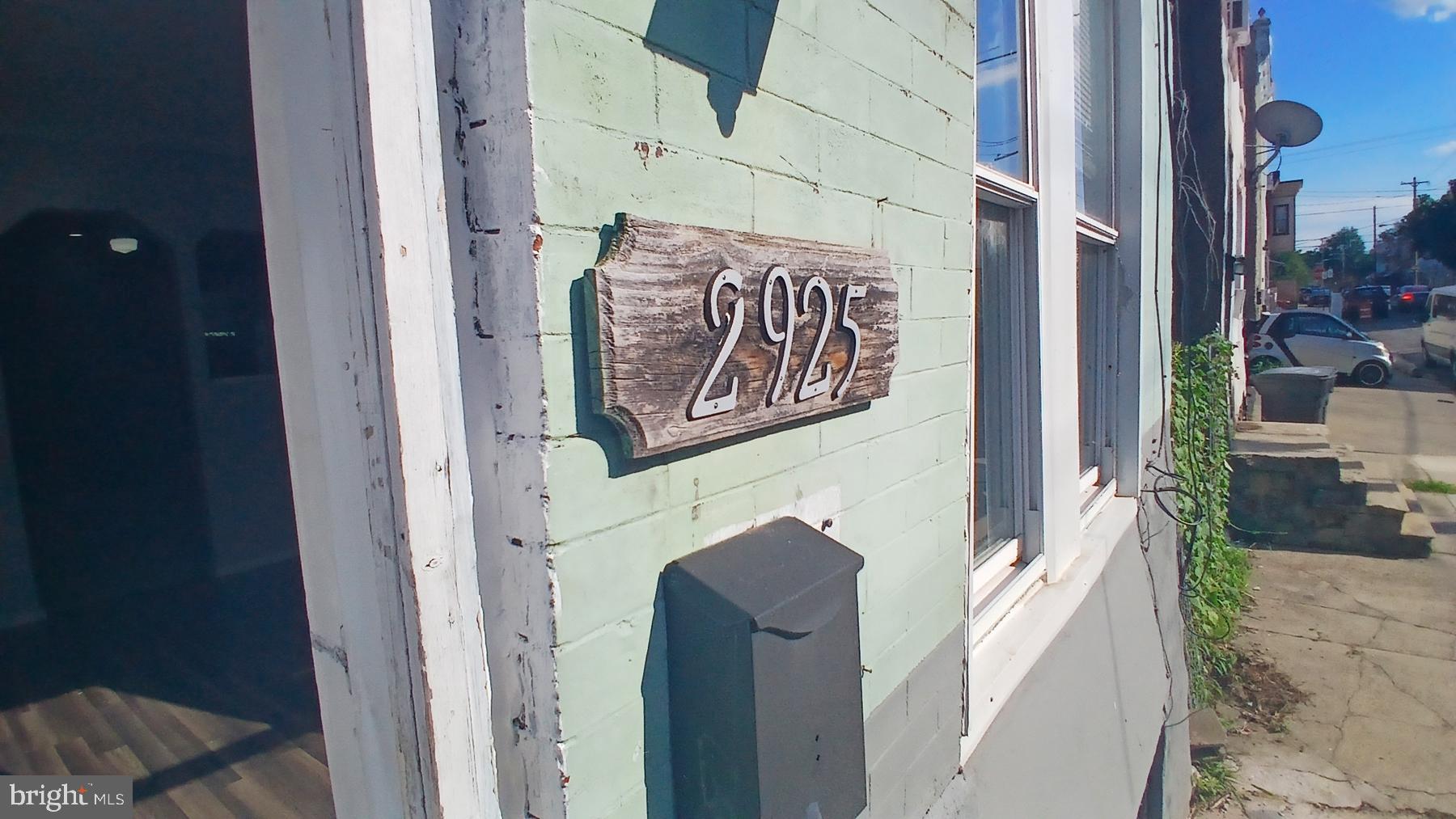 a door with a tree on the side of a house