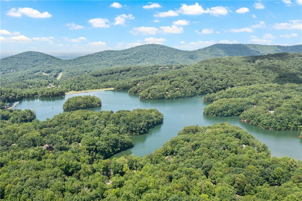 an aerial view of a house with a yard and lake view