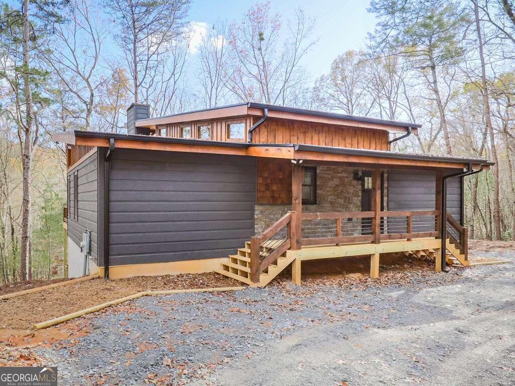 a backyard of a house with table and chairs