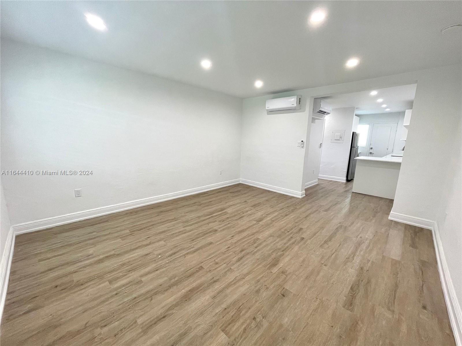 a view of a room with wooden floor