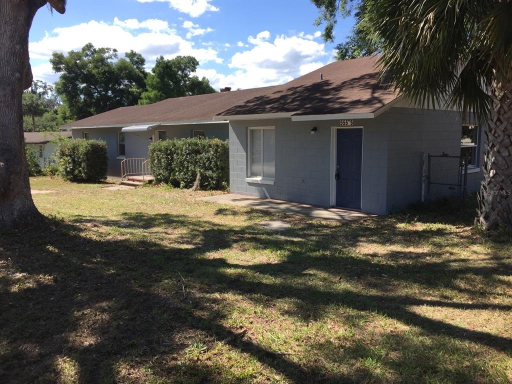 a view of a house with a yard