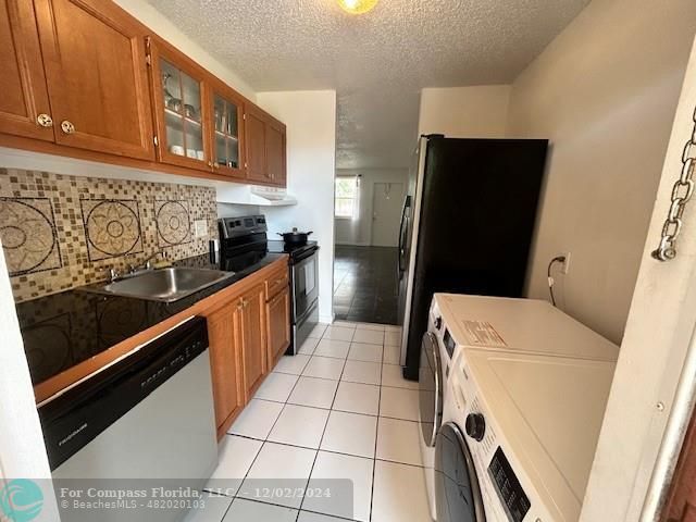 a kitchen with stainless steel appliances a refrigerator and a stove