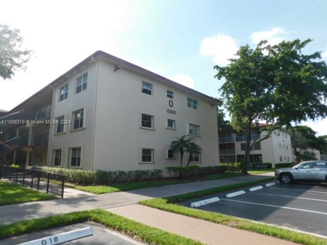 a view of a white house with a yard