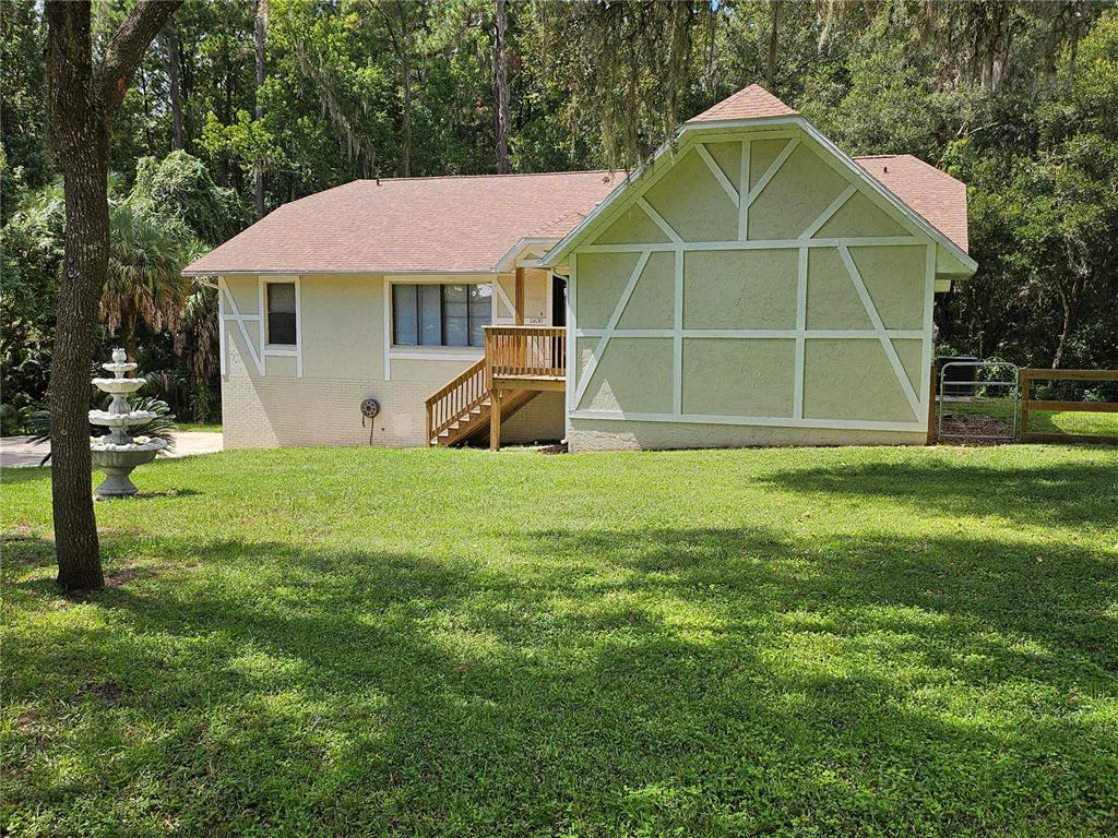 a front view of a house with a yard and trees