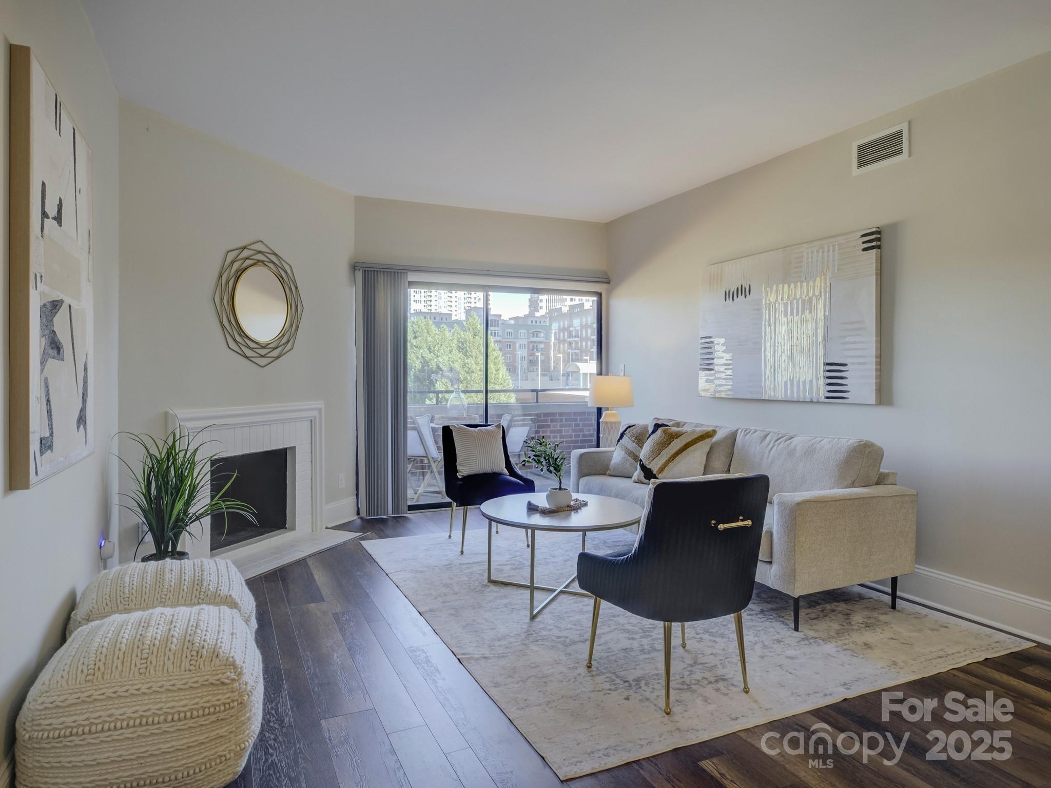 a living room with furniture a fireplace a potted plant and a fireplace