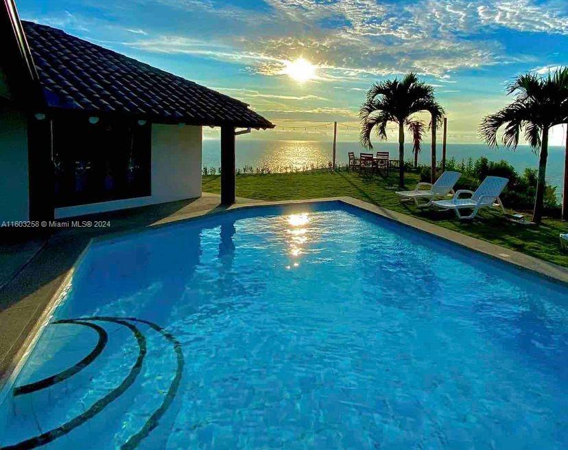 a view of swimming pool outdoor seating and yard