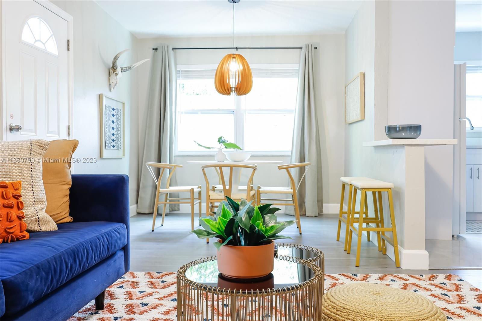 a living room with furniture and a potted plant