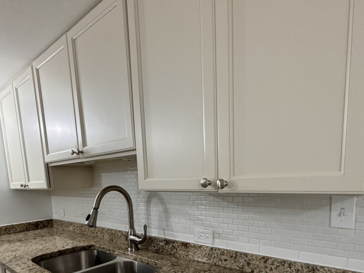 a close view of a sink and cabinets