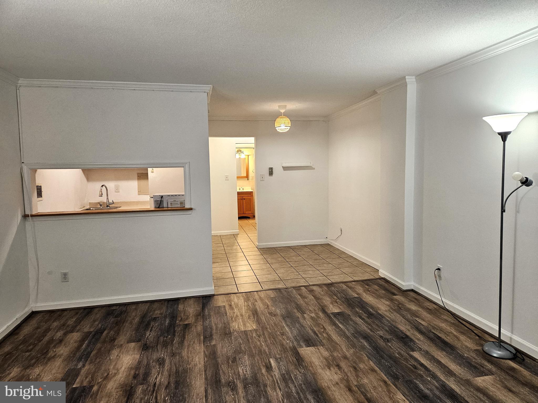 a view of a room with wooden floor and cabinet