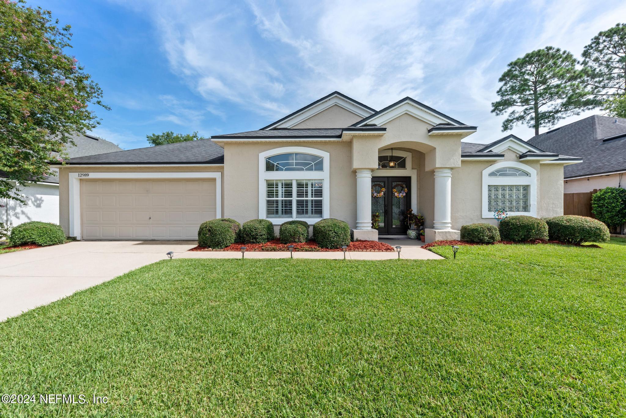 a front view of a house with a yard and porch