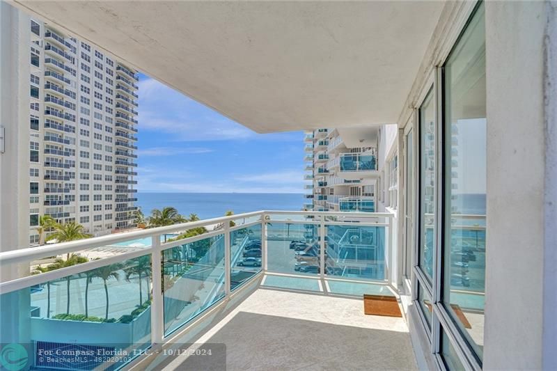 a view of balcony with a small yard