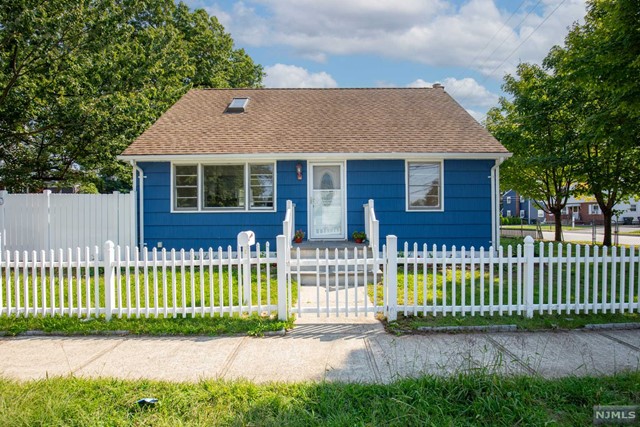 a front view of a house with a garden and plants