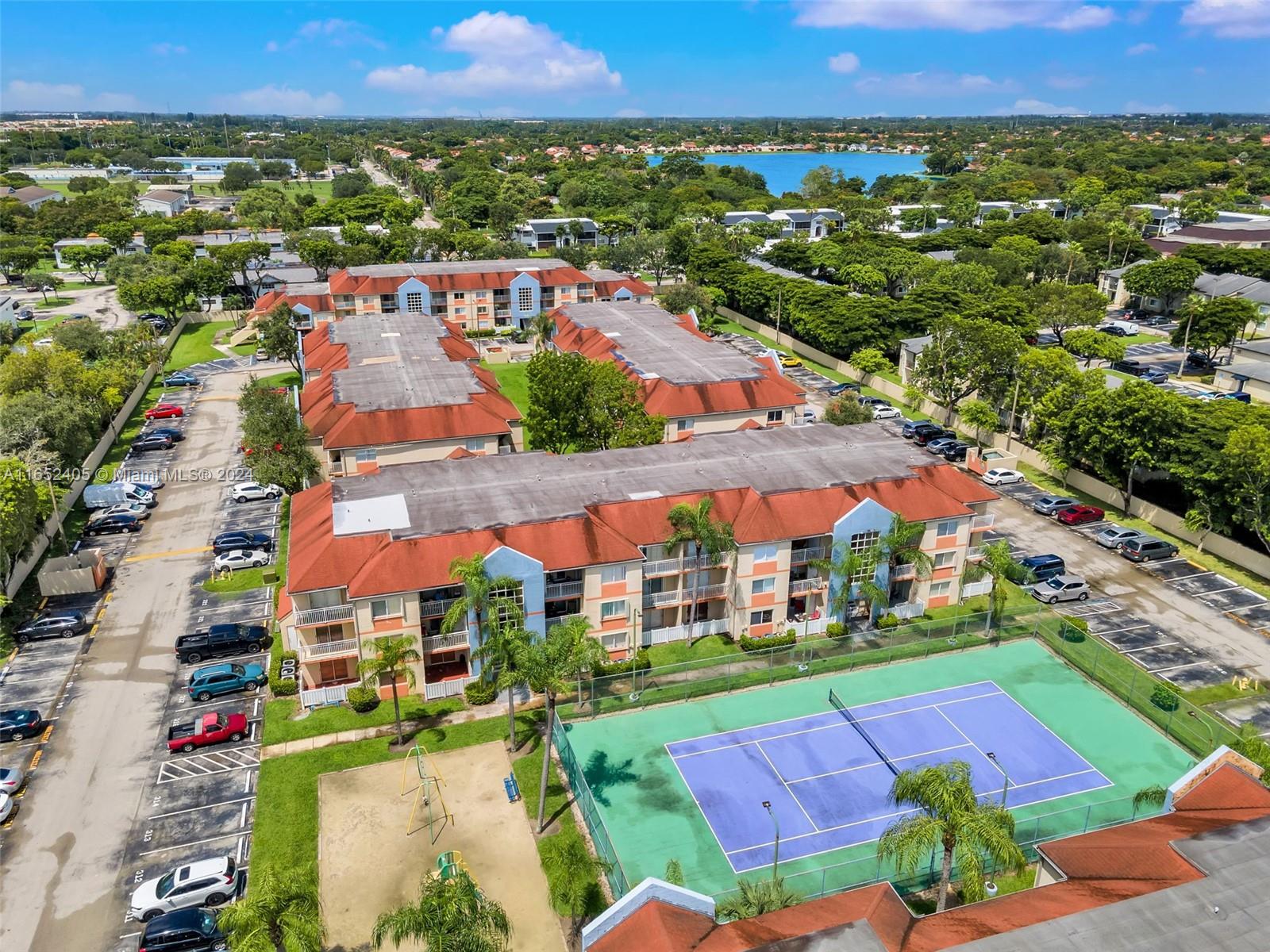 an aerial view of residential houses with outdoor space and street view