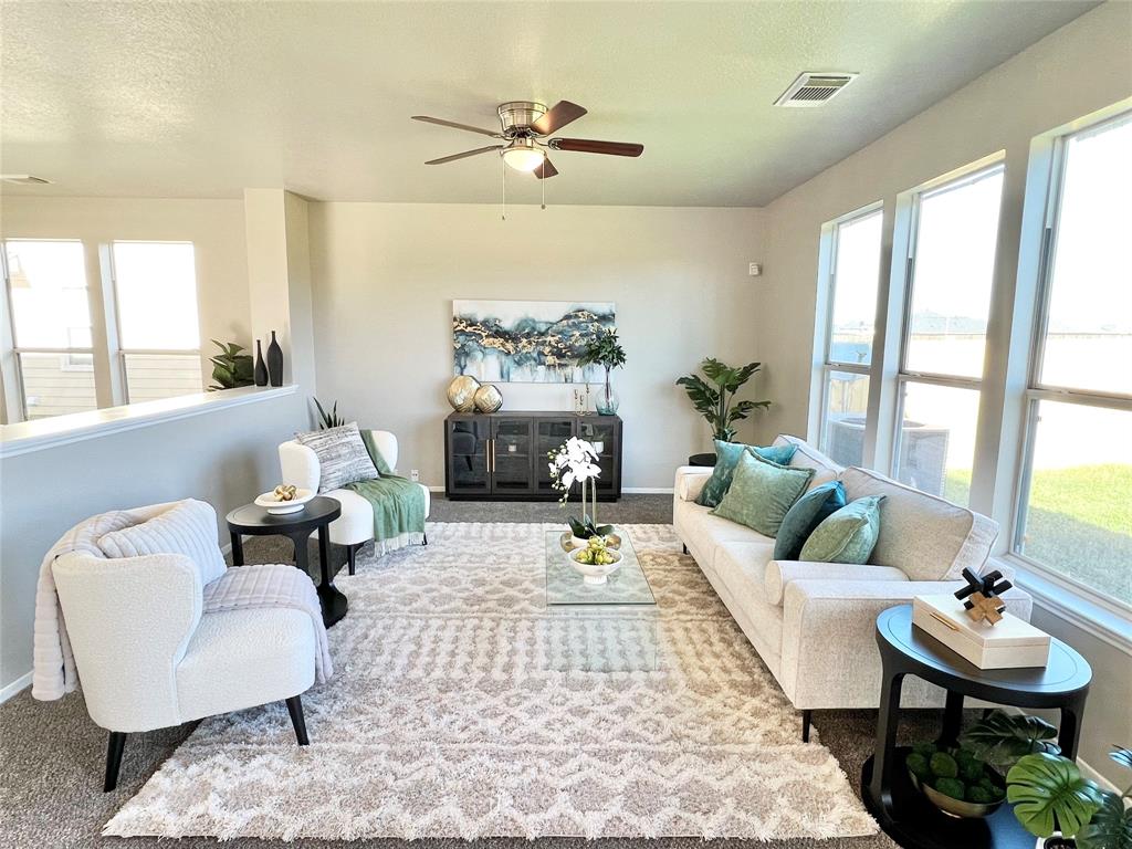 a living room with furniture and a large window