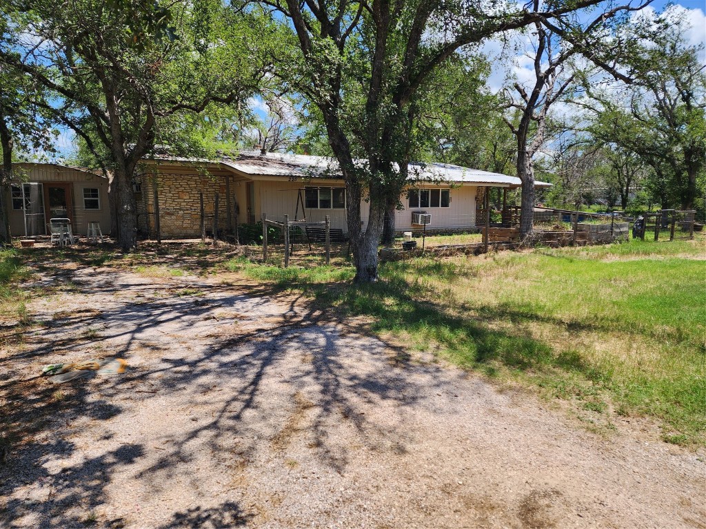 a view of a house with yard and sitting area