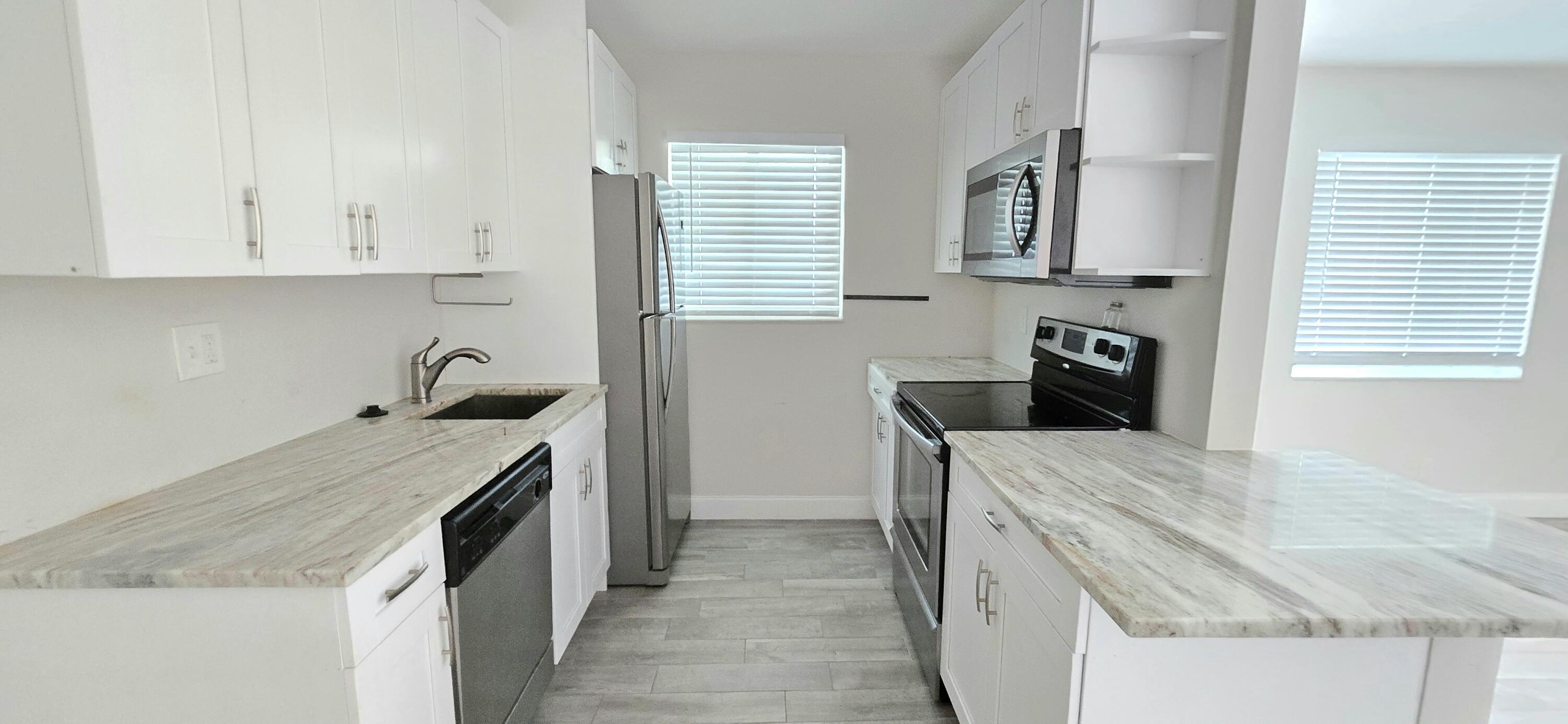 a kitchen that has a sink and a stove in it