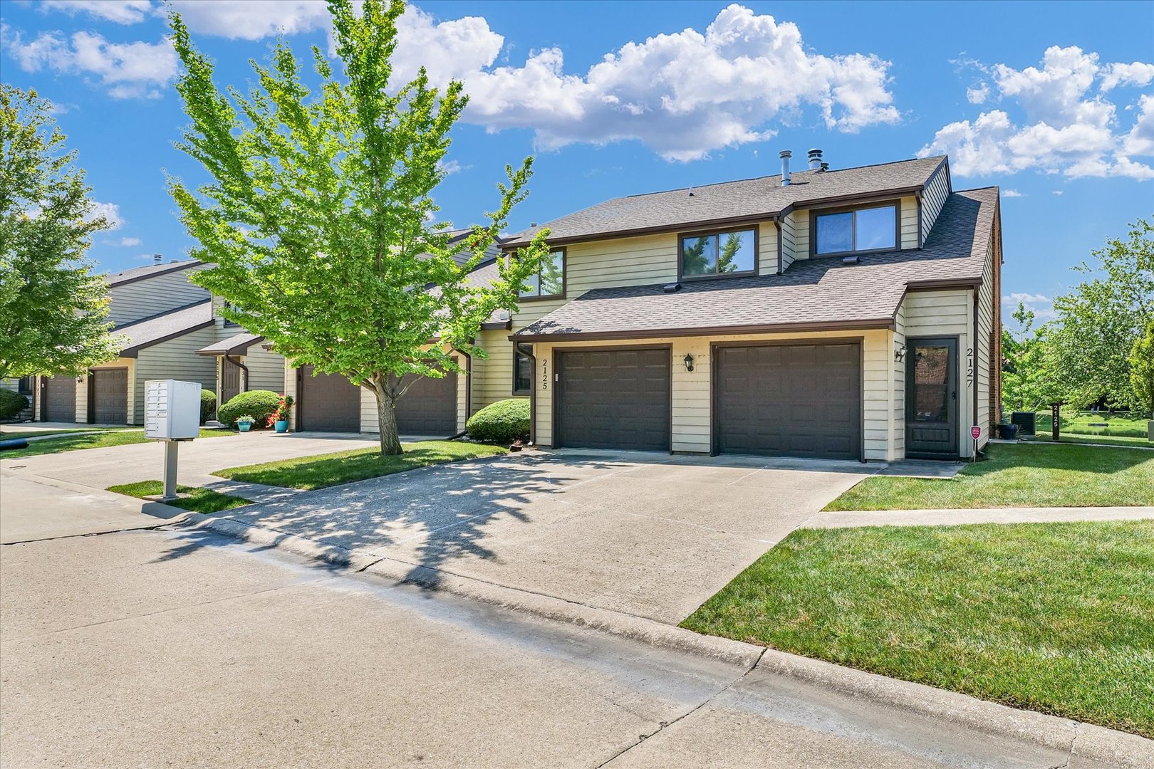 a front view of a house with a yard and a garage