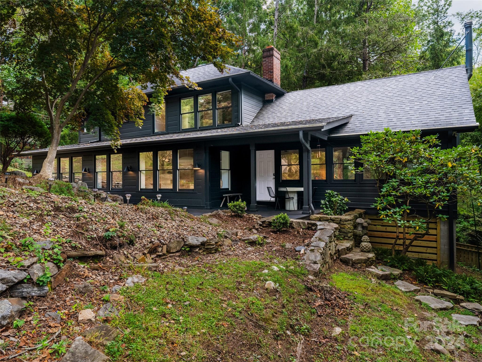 a view of a house with a yard and sitting area