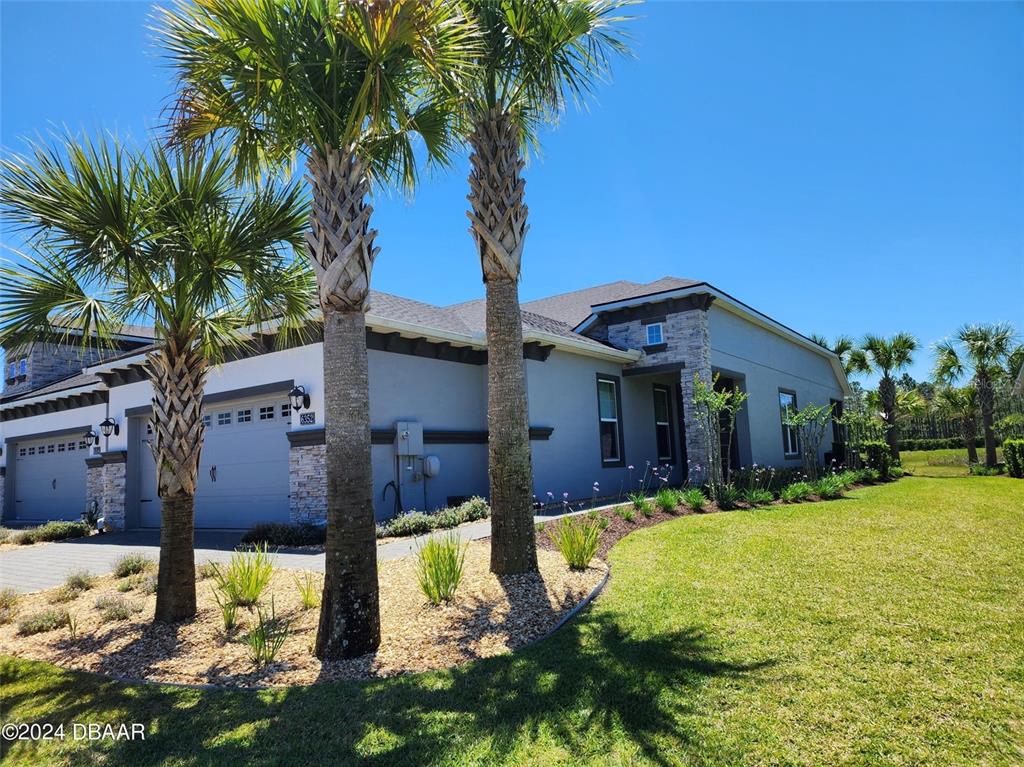 a front view of house with yard and trees