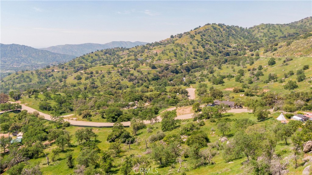 a view of a field with a mountain in the background