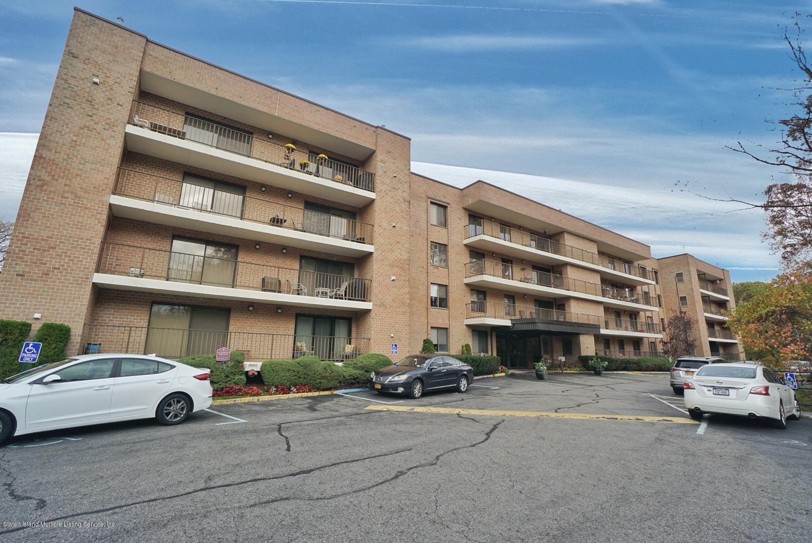 a front view of a building with parking