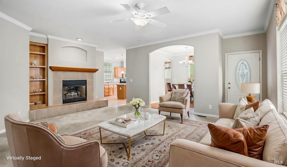 a living room with furniture a fireplace and a window