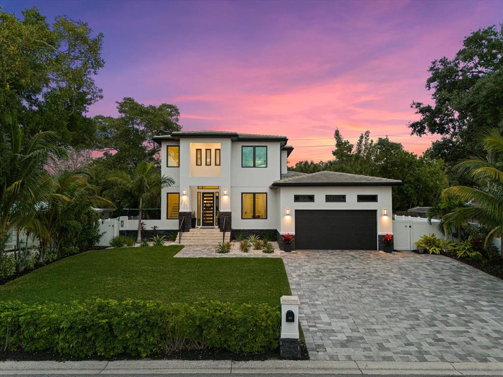 a front view of a house with a yard fire pit and outdoor seating