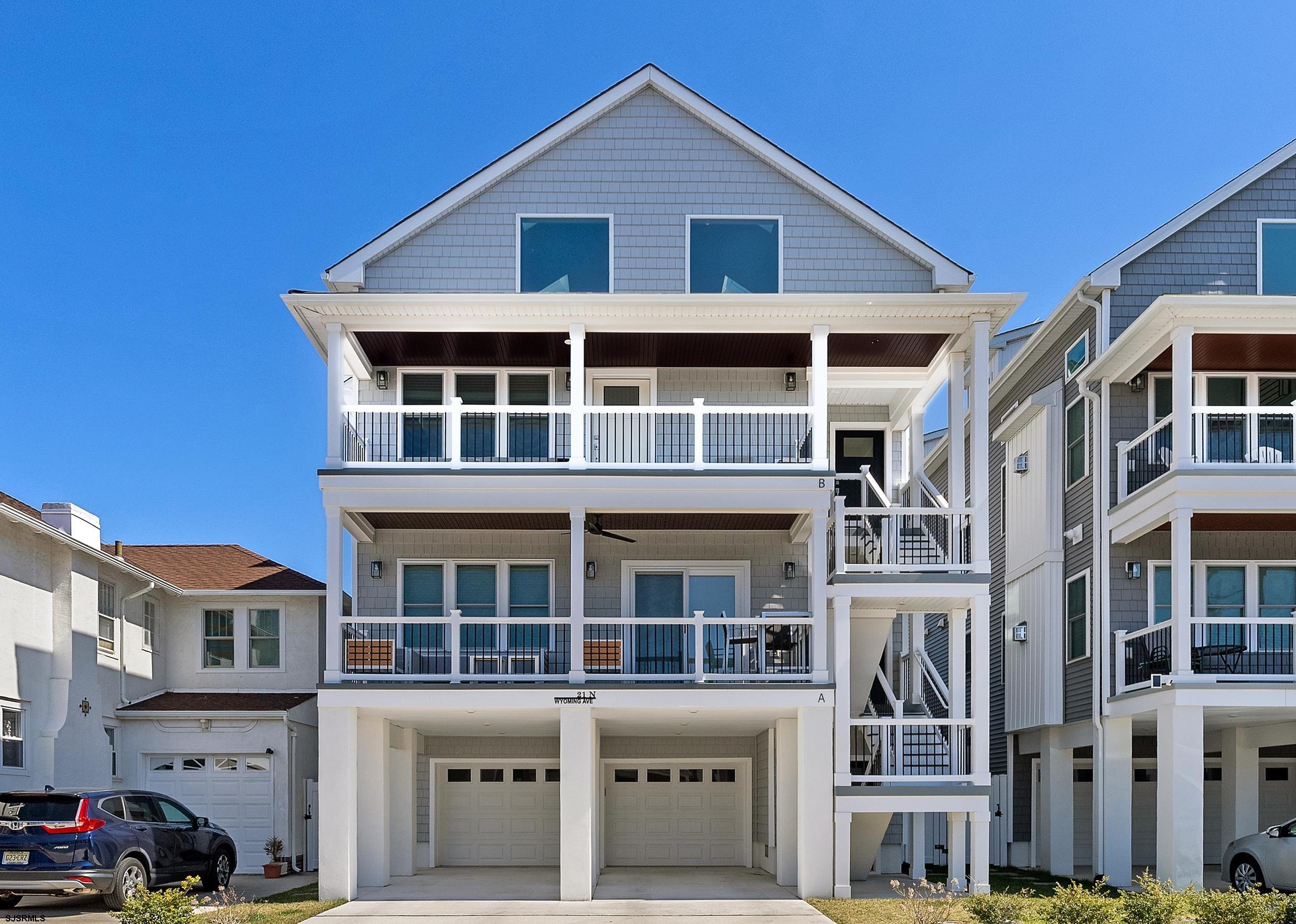 a front view of a residential apartment building with a yard