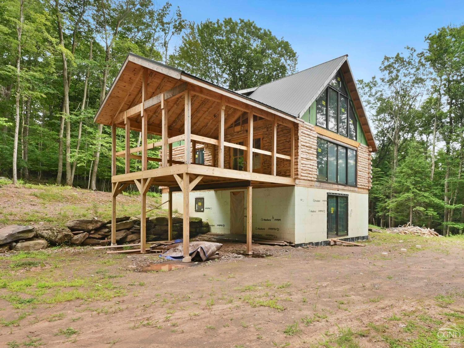 a view of a house with backyard and sitting area