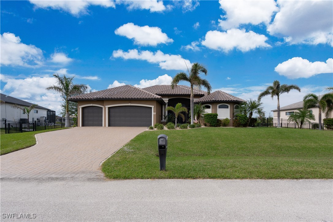 a front view of a house with a garden and yard