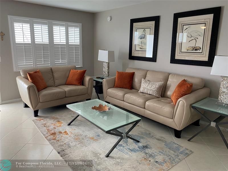 a living room with furniture and a window