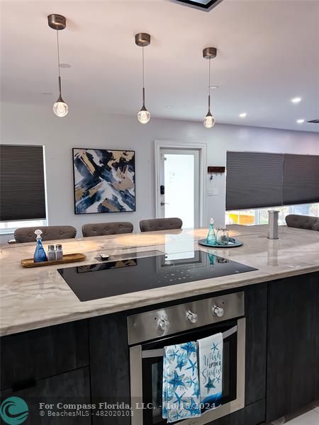 a kitchen with stainless steel appliances a sink stove and cabinets